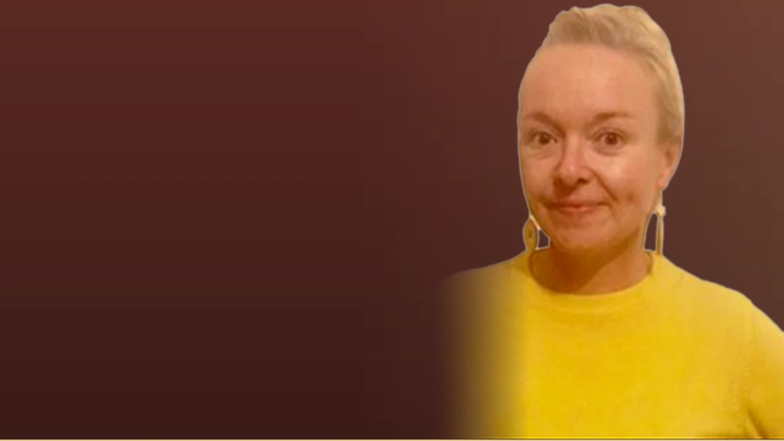 Caitlin O'Connel, an instructional designer, smiles warmly in a yellow sweater.